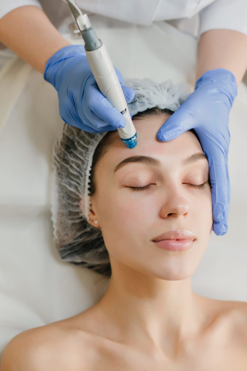 View from above of beautiful woman enjoying cosmetology procedures, rejuvenation in beauty salon. Dermatology, doctor at work, healthcare, therapy, botox. Place for text